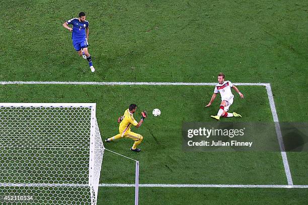 Mario Goetze of Germany scores his team's first goal past Sergio Romero of Argentina in extra time during the 2014 FIFA World Cup Brazil Final match...