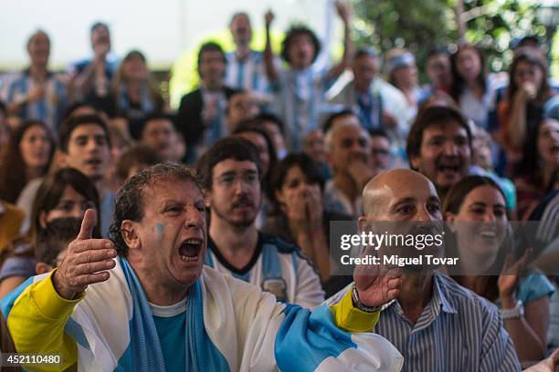 Football fans supporting the Argentina national team watching the FIFA World Cup final on a screen at the Argentina's Embassy in Mexico on July 13,...