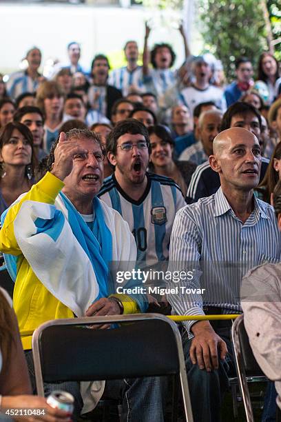 Football fans supporting the Argentina national team watching the FIFA World Cup final on a screen at the Argentina's Embassy in Mexico on July 13,...