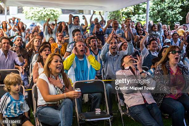 Football fans supporting the Argentina national team watching the FIFA World Cup final on a screen at the Argentina's Embassy in Mexico on July 13,...