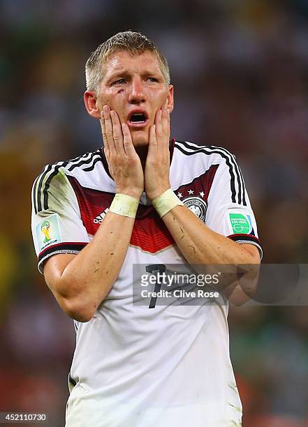 Bastian Schweinsteiger celebrates defeating Argentina 1-0 in the 2014 FIFA World Cup Brazil Final match between Germany and Argentina at Maracana on...