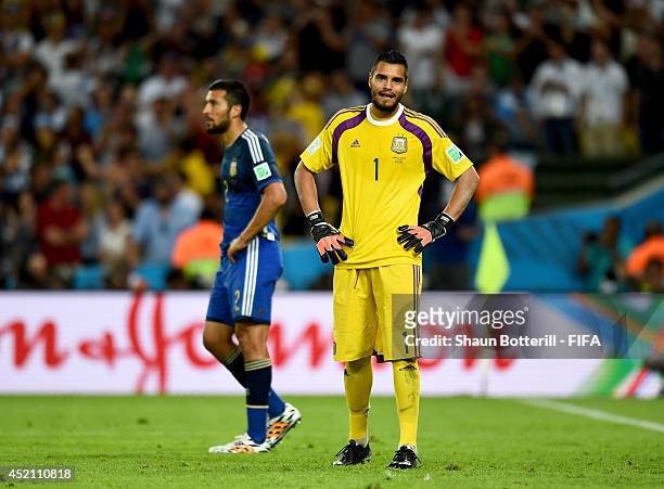 Sergio Romero of Argentina reacts after conceding the first goal to Germany during the 2014 FIFA World Cup Brazil Final match between Germany and...