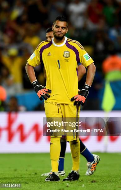 Sergio Romero of Argentina reacts after conceding the first goal to Germany during the 2014 FIFA World Cup Brazil Final match between Germany and...