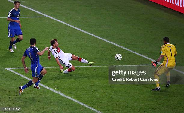 Mario Goetze of Germany scores his team's first goal past Sergio Romero of Argentina in extra time during the 2014 FIFA World Cup Brazil Final match...