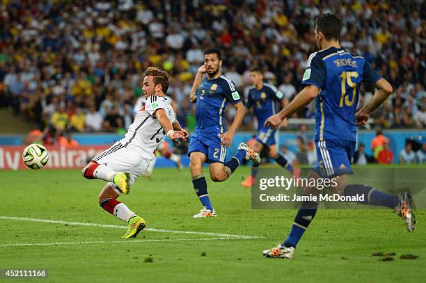 Mario Goetze of Germany scores his team's first goal past Sergio Romero of Argentina in extra time during the 2014 FIFA World Cup Brazil Final match...