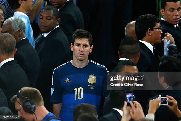 Dejected Lionel Messi of Argentina looks on after being defeated by Germany 1-0 in extra time during the 2014 FIFA World Cup Brazil Final match...