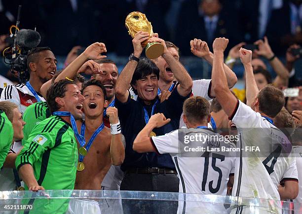 Head coach Joachim Loew of Germany lifts the World Cup to celebrate during the award ceremony after the 2014 FIFA World Cup Brazil Final match...
