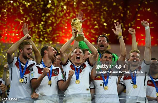 Bastian Schweinsteiger of Germany lifts the World Cup to celebrate with his teammates during the award ceremony after the 2014 FIFA World Cup Brazil...