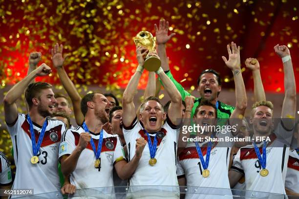 Bastian Schweinsteiger of Germany lifts the World Cup to celebrate with his teammates during the award ceremony after the 2014 FIFA World Cup Brazil...