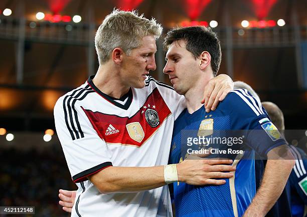 Bastian Schweinsteiger of Germany hugs Lionel Messi of Argentina after Germany's 1-0 victory in extra time during the 2014 FIFA World Cup Brazil...