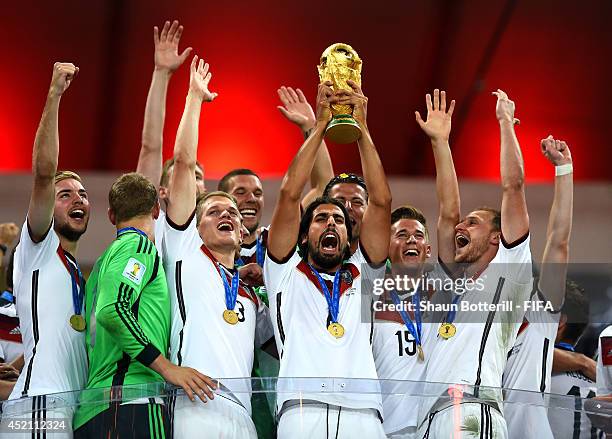 Sami Khedira of Germany lifts the World Cup to celebrate with his teammates during the award ceremony after the 2014 FIFA World Cup Brazil Final...