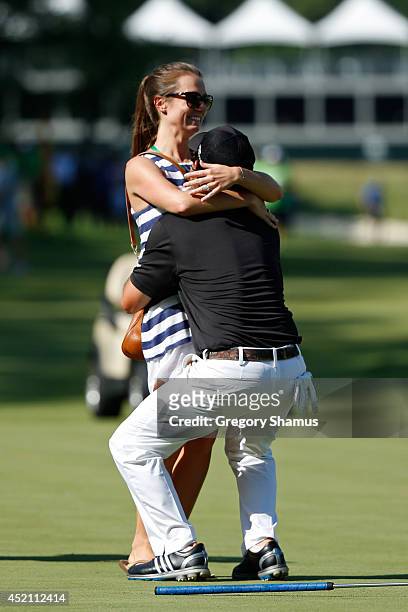 Brian Harman embraces his fiance Kelly Van Slyke after winning the John Deere Classic held at TPC Deere Run on July 13, 2014 in Silvis, Illinois.