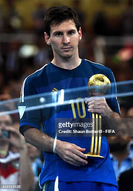 Lionel Messi of Argentina receives the Golden Ball trophy during the award ceremony after the 2014 FIFA World Cup Brazil Final match between Germany...