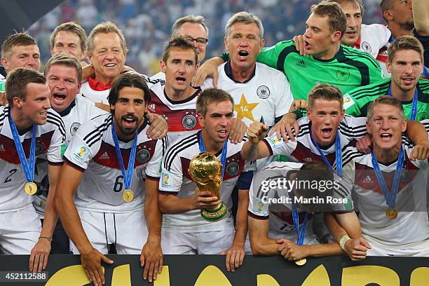 Germany celebrate with the World Cup trophy after defeating Argentina 1-0 in extra time during the 2014 FIFA World Cup Brazil Final match between...