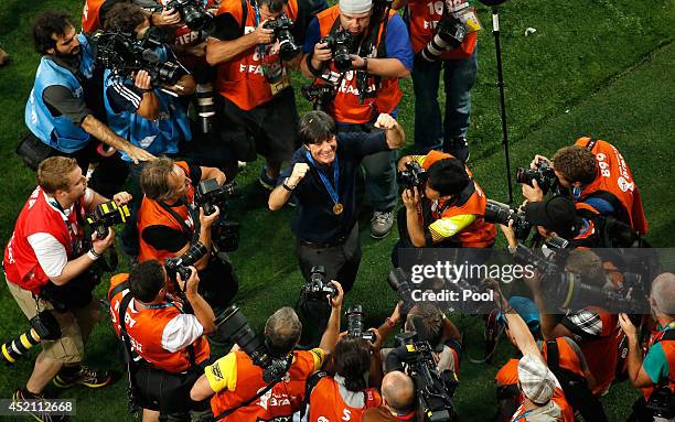 Head coach Joachim Loew of Germany celebrates after defeating Argentina 1-0 in extra time during the 2014 FIFA World Cup Brazil Final match between...