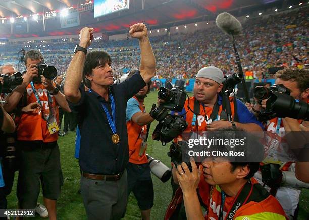 Head coach Joachim Loew of Germany celebrates after defeating Argentina 1-0 in extra time during the 2014 FIFA World Cup Brazil Final match between...
