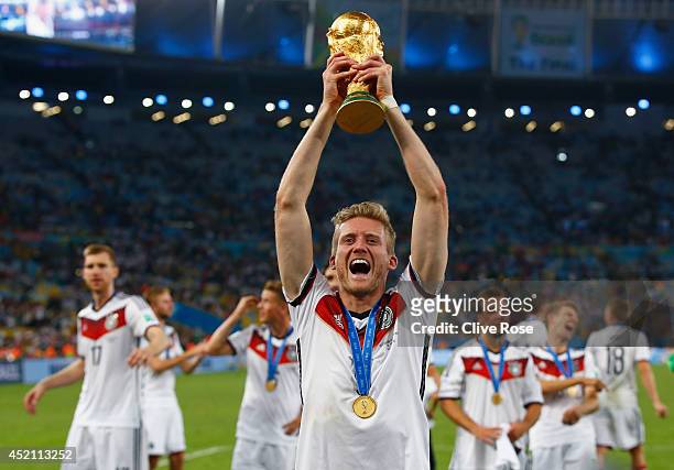 Andre Schuerrle of Germany celebrates with the World Cup trophy after defeating Argentina 1-0 in extra time during the 2014 FIFA World Cup Brazil...