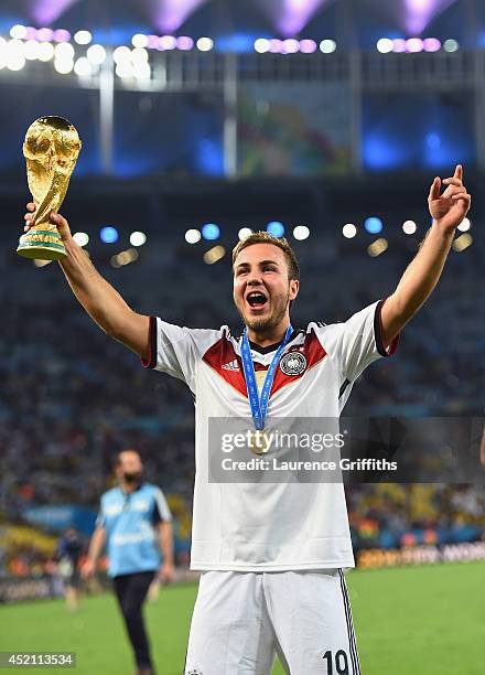 Mario Goetze of Germany celebrates with the World Cup trophy after defeating Argentina 1-0 in extra time during the 2014 FIFA World Cup Brazil Final...