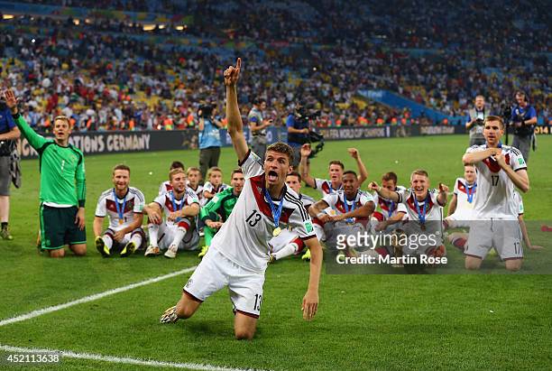 Thomas Mueller of Germany celebrate with teammates after defeating Argentina 1-0 in extra time during the 2014 FIFA World Cup Brazil Final match...