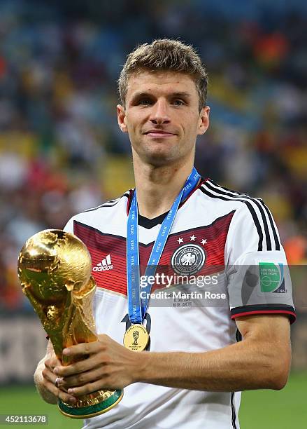 Thomas Mueller of Germany celebrates with the World Cup trophy after defeating Argentina 1-0 in extra time during the 2014 FIFA World Cup Brazil...