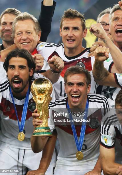 Philipp Lahm of Germany lifts the trophy during the 2014 World Cup final match between Germany and Argentina at The Maracana Stadium on July 13, 2014...