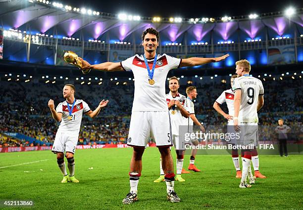 Mats Hummels of Germany celebrates with the World Cup trophy after the 2014 FIFA World Cup Brazil Final match between Germany and Argentina at...