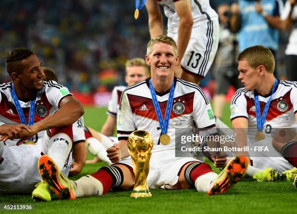 Bastian Schweinsteiger of Germany celebrate with the World Cup trophy after the 2014 FIFA World Cup Brazil Final match between Germany and Argentina...