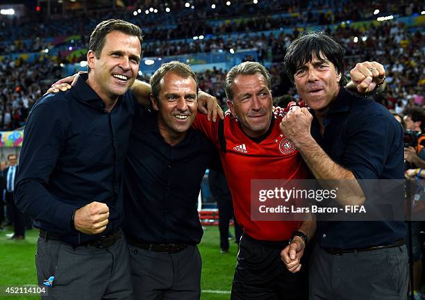 Head coach Joachim Loew celebrate winning the World Cup with team manager Oliver Bierhoff , assistant coach Hansi Flick and goal keeper coach Andreas...