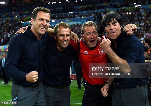 Head coach Joachim Loew celebrate winning the World Cup with team manager Oliver Bierhoff , assistant coach Hansi Flick and goal keeper coach Andreas...