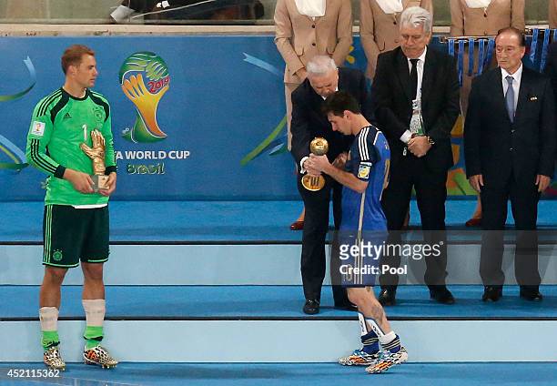 Golden Glove winner Manuel Neuer of Germany looks on as Jose Maria Marin, President of the CBF, presents Lionel Messi of Argentina with the Golden...