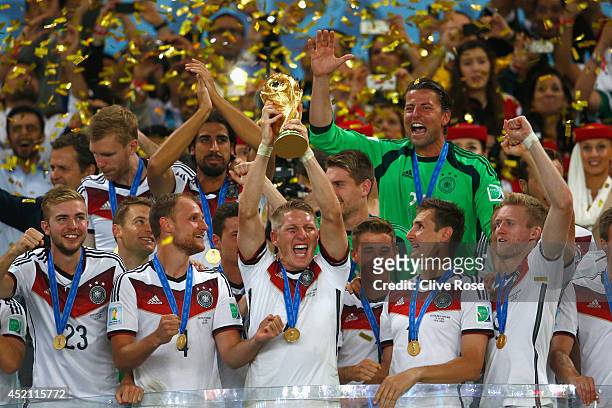 Bastian Schweinsteiger of Germany lifts the World Cup trophy with teammates after defeating Argentina 1-0 in extra time during the 2014 FIFA World...