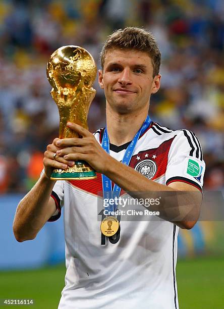 Thomas Mueller of Germany celebrates with the World Cup trophy after defeating Argentina 1-0 in extra time during the 2014 FIFA World Cup Brazil...