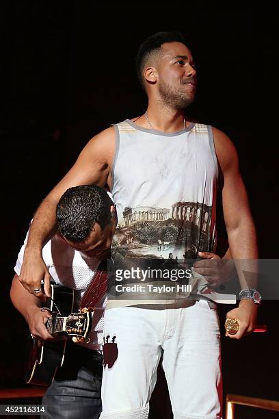 Lenny Santos and Romeo Santos of Aventura perform in concert at Yankee Stadium on July 12, 2014 in New York City.
