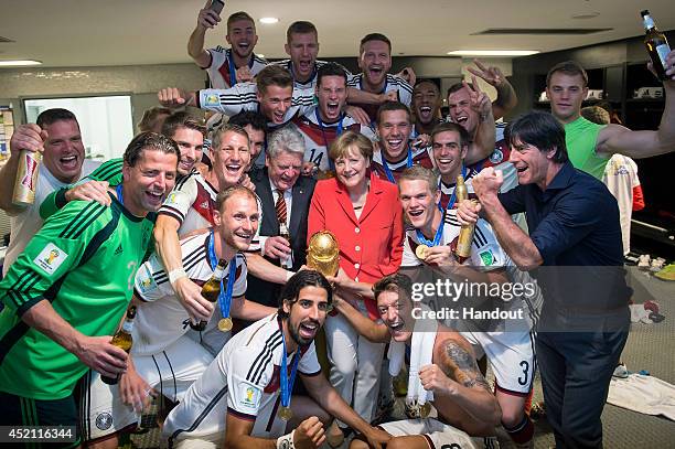 In this handout photo provided by the German Government Press Office , German Chancellor Angela Merkel and German President Joachim Gauck celebrate...