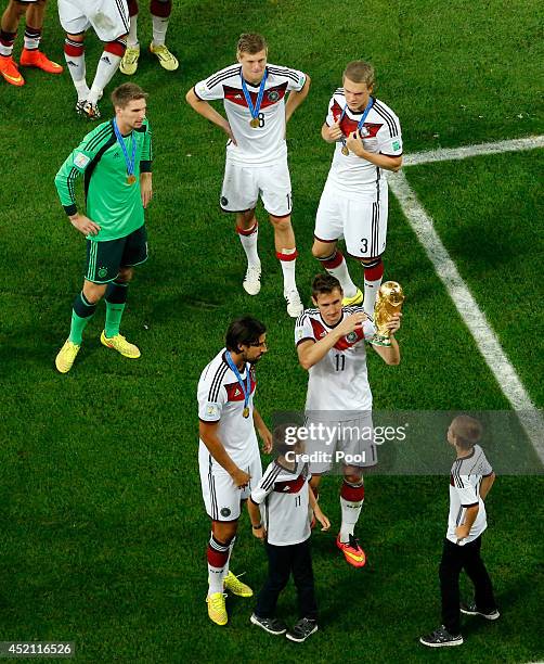 Miroslav Klose of Germany celebrates with the World Cup trophy and his sons after defeating Argentina 1-0 in extra time during the 2014 FIFA World...