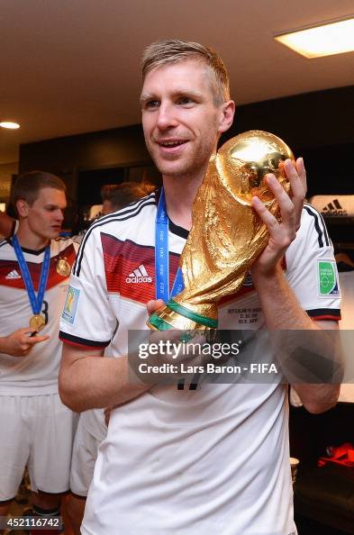 Per Mertesacker of Germany holds up the World Cup trophy in the... News