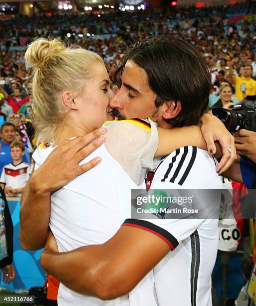 Sami Khedira of Germany celebrates with girlfriend Lena Gercke after defeating Argentina 1-0 in extra time during the 2014 FIFA World Cup Brazil...
