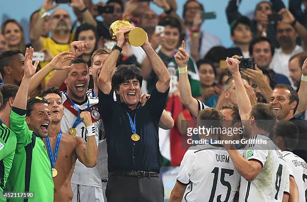 Joachim Loew of Germany lifts the World Cup trophy with his team after defeating Argentina 1-0 in extra time during the 2014 FIFA World Cup Brazil...