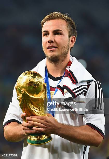 Mario Goetze of Germany celebrates with the World Cup trophy after defeating Argentina 1-0 in extra time during the 2014 FIFA World Cup Brazil Final...