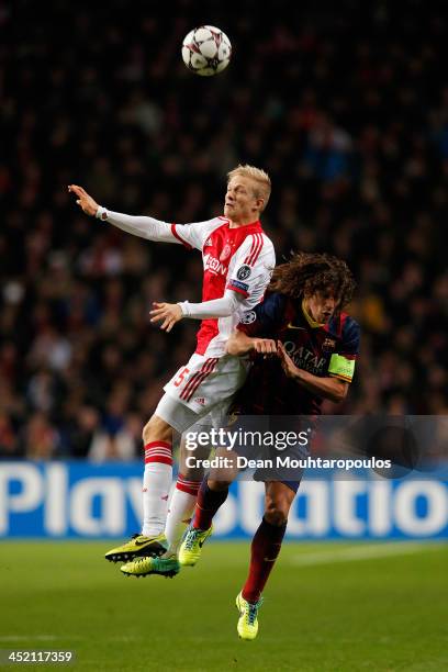 Nicolai Boilesen of Ajax and Carles Puyol of Barcelona battle for the header during the UEFA Champions League Group H match between Ajax Amsterdam...