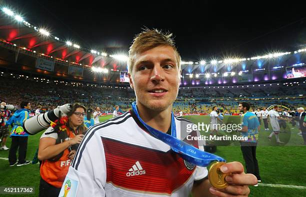 Toni Kroos of Germany celebrates with his medal after defeating Argentina 1-0 in extra time during the 2014 FIFA World Cup Brazil Final match between...