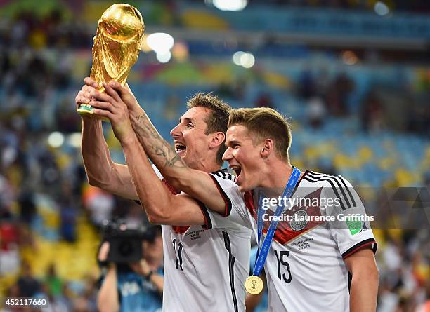 Miroslav Klose and Erik Durm of Germany celebrate with the World Cup trophy after defeating Argentina 1-0 in extra time during the 2014 FIFA World...