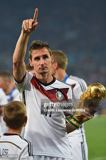 Miroslav Klose of Germany celebrates with the World Cup trophy after defeating Argentina 1-0 in extra time during the 2014 FIFA World Cup Brazil...