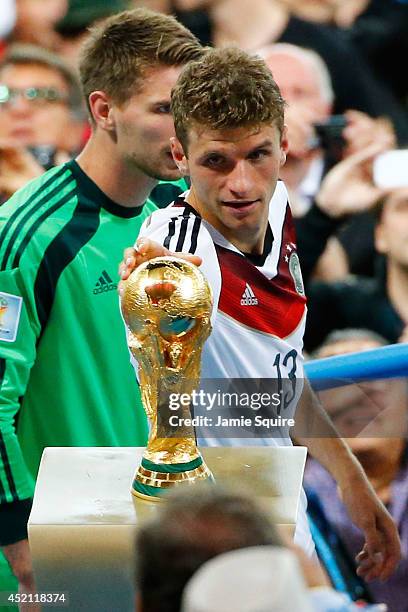 Thomas Mueller of Germany touches the World Cup trophy after defeating Argentina 1-0 in extra time during the 2014 FIFA World Cup Brazil Final match...