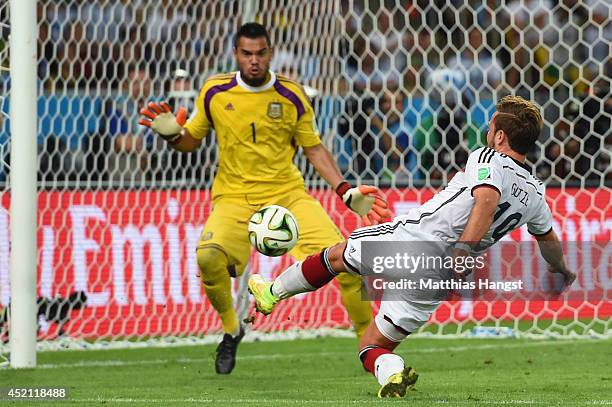 Mario Goetze of Germany scores his team's first goal past Sergio Romero of Argentina in extra time during the 2014 FIFA World Cup Brazil Final match...