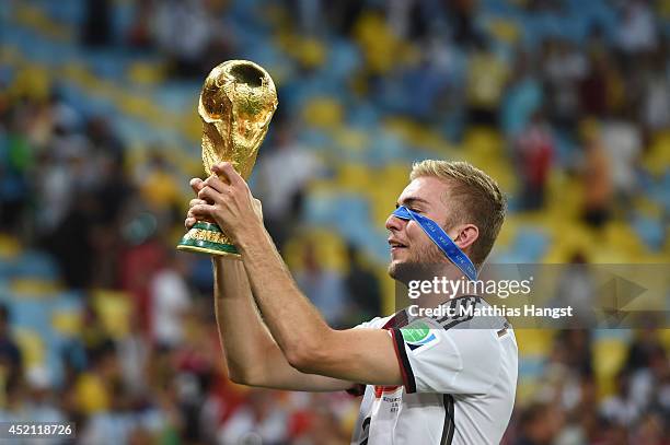 Christoph Kramer of Germany celebrates with the World Cup trophy after defeating Argentina 1-0 in extra time during the 2014 FIFA World Cup Brazil...