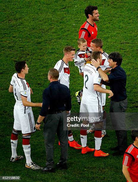 Head coach Joachim Loew of Germany celebrates with his players Julian Draxler, Erik Durm, Kevin Grosskreutz and Lukas Podolski of Germany after...