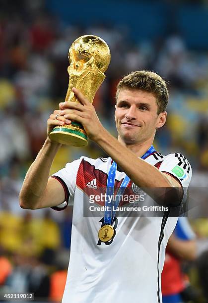 Thomas Mueller of Germany celebrates with the World Cup trophy after defeating Argentina 1-0 in extra time during the 2014 FIFA World Cup Brazil...