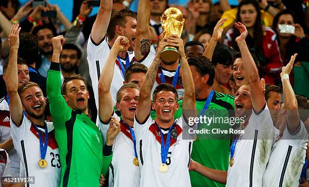 Erik Durm of Germany celebrates with the World Cup trophy after defeating Argentina 1-0 in extra time during the 2014 FIFA World Cup Brazil Final...