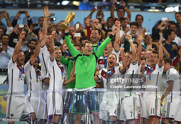 Manuel Neuer of Germany lifts the World Cup trophy with his team after defeating Argentina 1-0 in extra time during the 2014 FIFA World Cup Brazil...